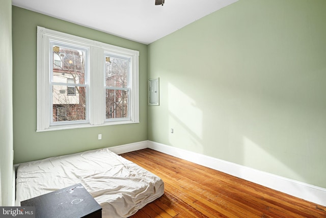 unfurnished bedroom with ceiling fan and hardwood / wood-style floors