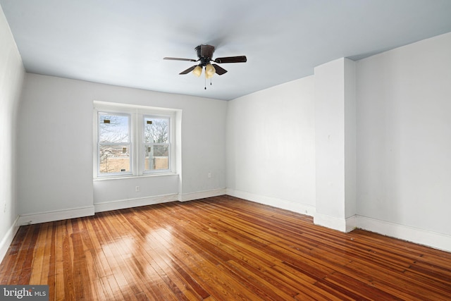 unfurnished room with hardwood / wood-style floors and ceiling fan