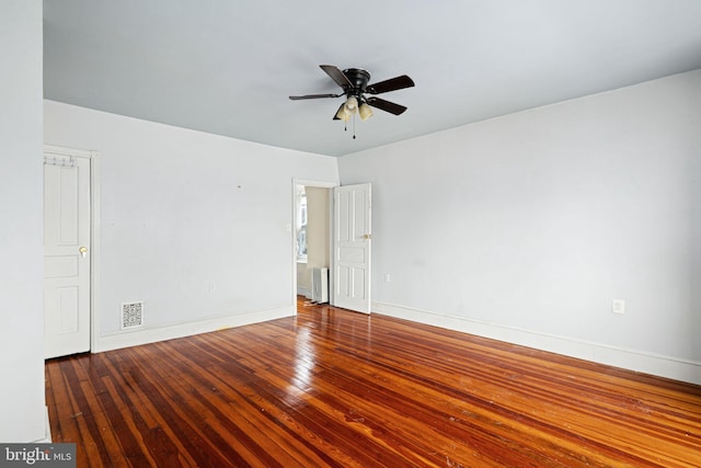 empty room with hardwood / wood-style flooring and ceiling fan