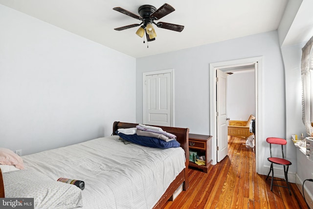 bedroom with wood-type flooring and ceiling fan