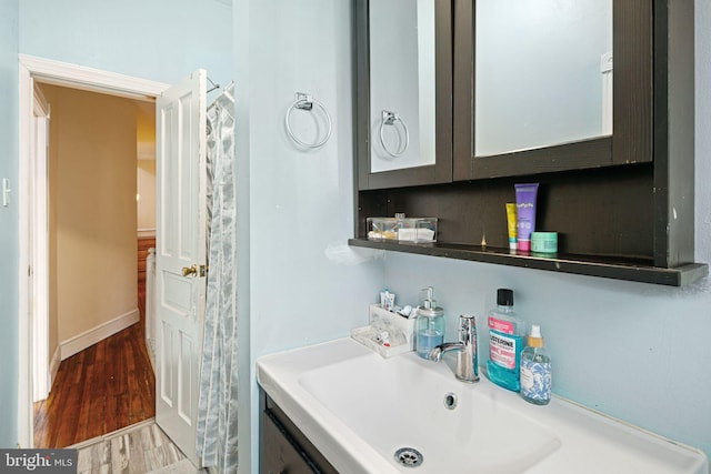 bathroom featuring hardwood / wood-style flooring and vanity