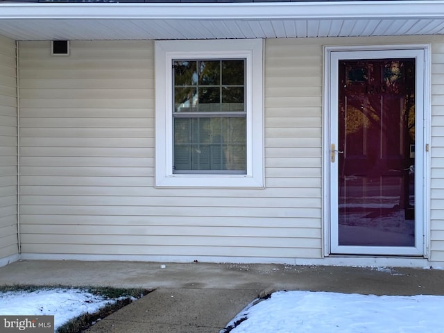 view of snow covered property entrance