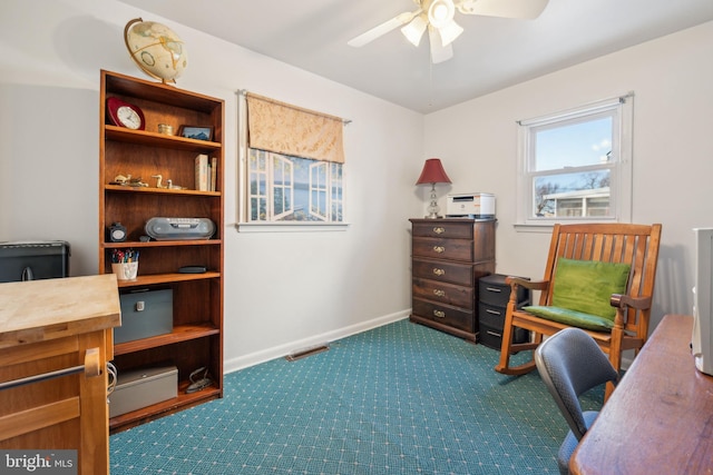 carpeted home office with ceiling fan