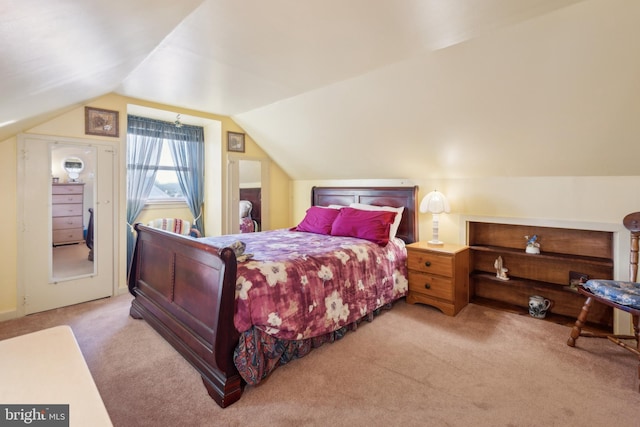 carpeted bedroom featuring vaulted ceiling