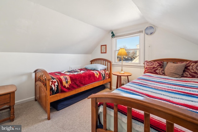 bedroom featuring carpet flooring and vaulted ceiling