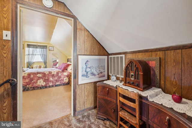 interior space featuring carpet flooring, wooden walls, and vaulted ceiling