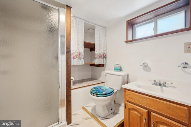 bathroom with vanity, toilet, and walk in shower