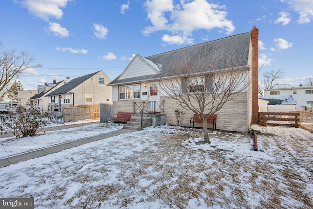 view of snow covered rear of property