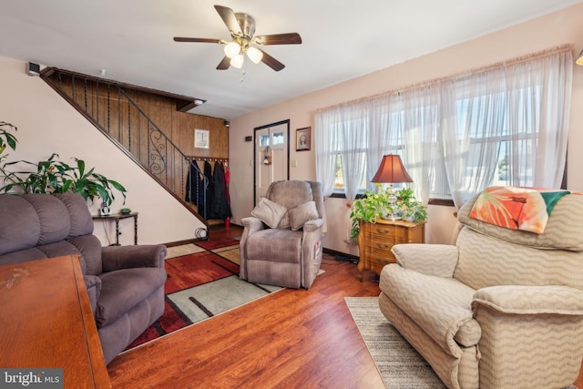 living room featuring hardwood / wood-style floors and ceiling fan