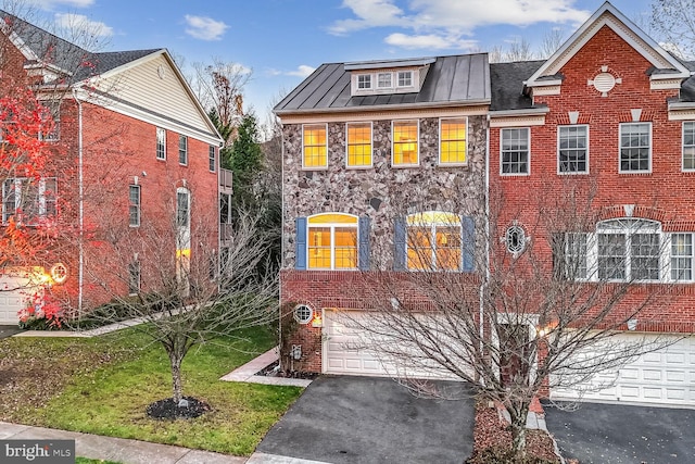 view of front of house with a garage and a front lawn