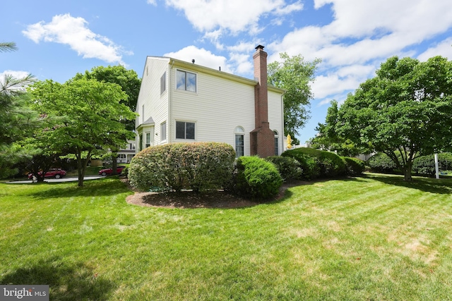 view of side of home featuring a lawn