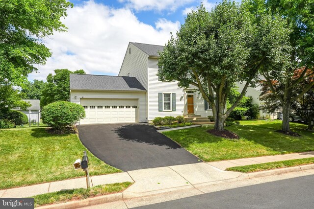 view of front of property featuring a front yard and a garage