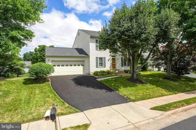 view of front of house featuring a front lawn and a garage