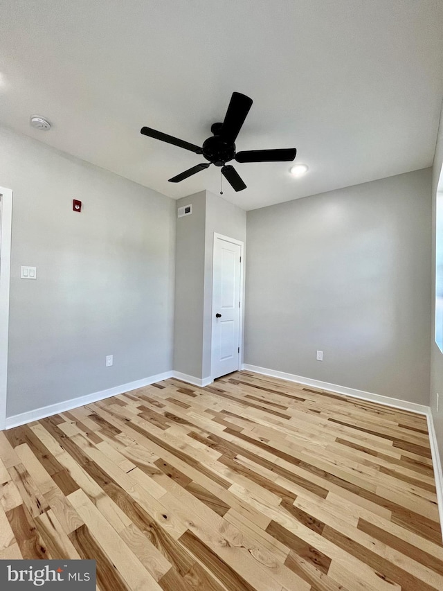 spare room featuring light hardwood / wood-style floors and ceiling fan