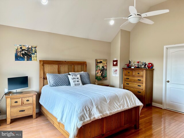 bedroom featuring ceiling fan, lofted ceiling, and hardwood / wood-style flooring