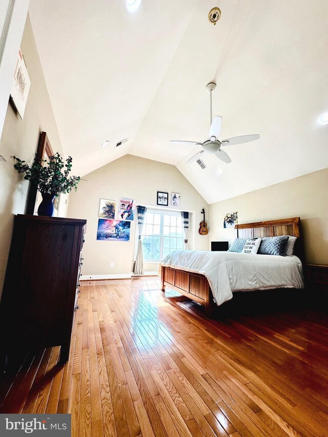 bedroom featuring ceiling fan, hardwood / wood-style floors, and lofted ceiling