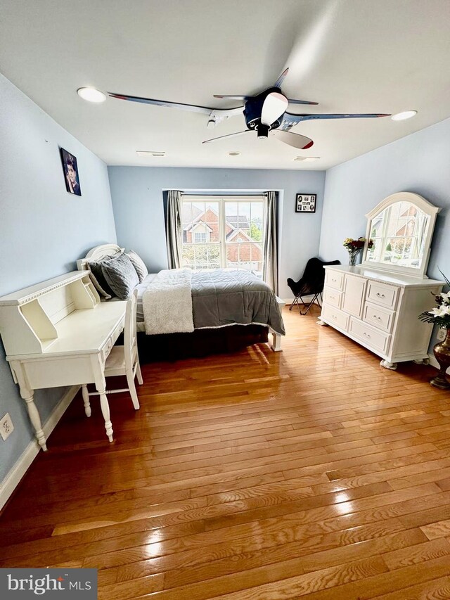 bedroom with ceiling fan and light wood-type flooring