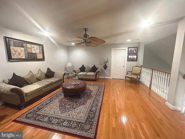 living room featuring ceiling fan and wood-type flooring