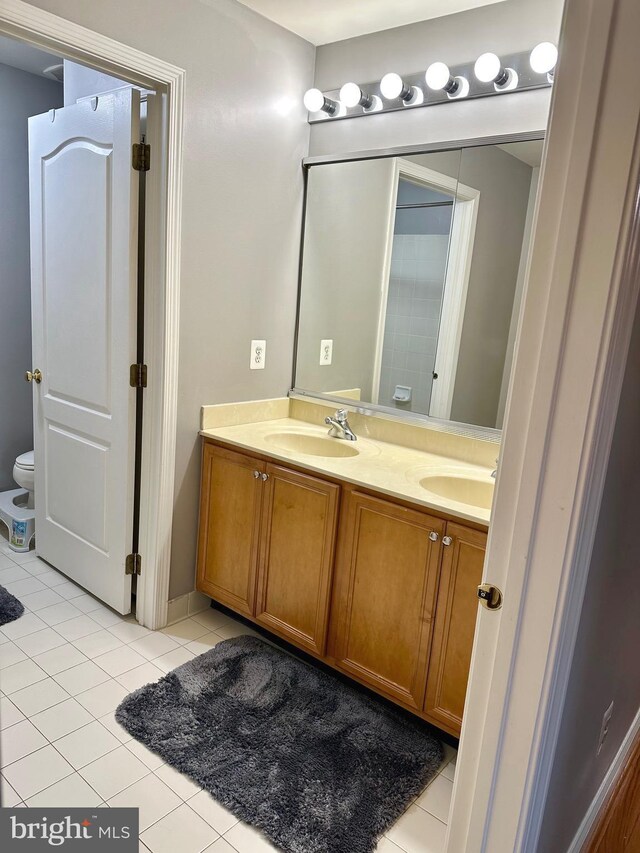 bathroom with tile patterned floors and vanity