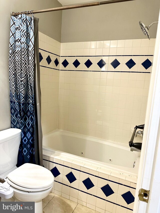 bathroom featuring tile patterned flooring, shower / bath combination with curtain, and toilet