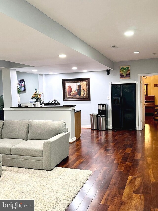 living room with dark hardwood / wood-style flooring