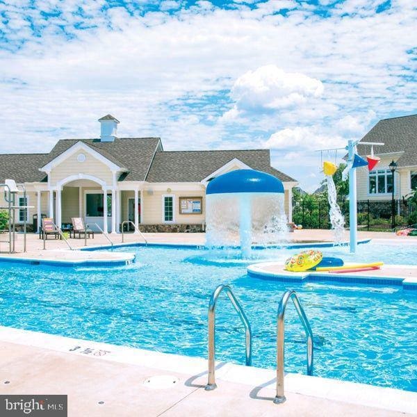 view of pool with pool water feature and a patio area