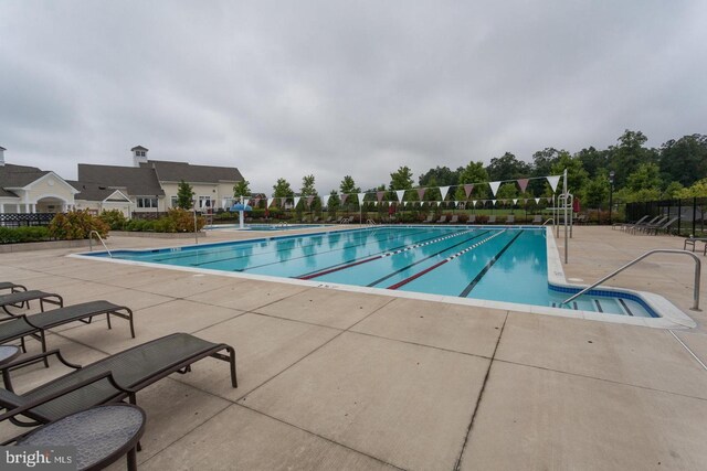 view of swimming pool with a patio area