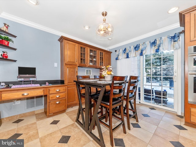 dining room with built in desk, light tile patterned floors, and ornamental molding