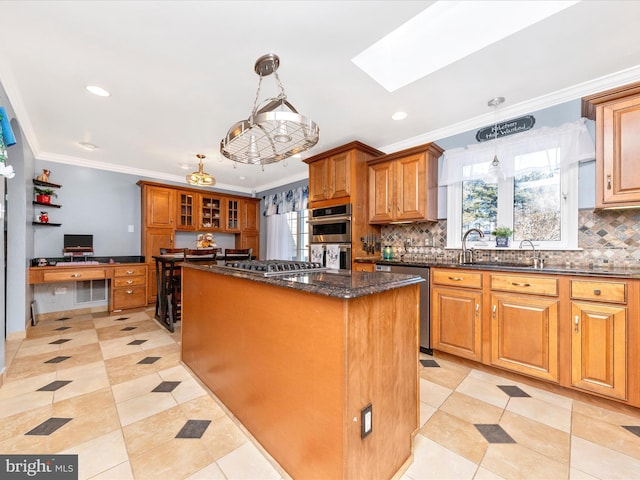 kitchen with stainless steel appliances, decorative light fixtures, dark stone counters, crown molding, and a center island