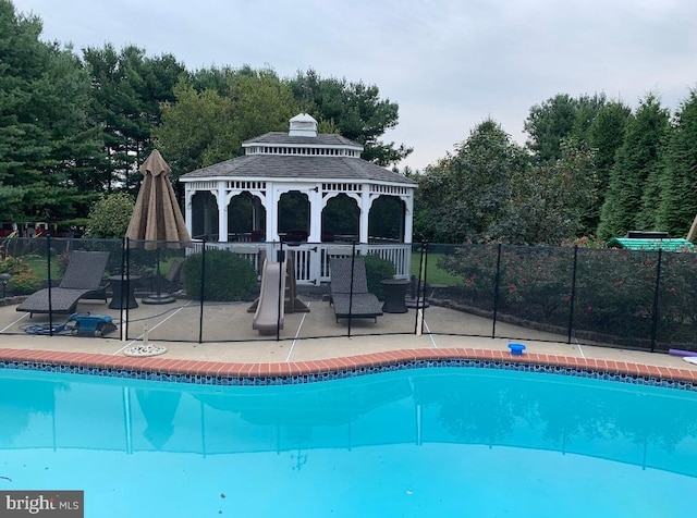 view of pool with a patio area and a gazebo