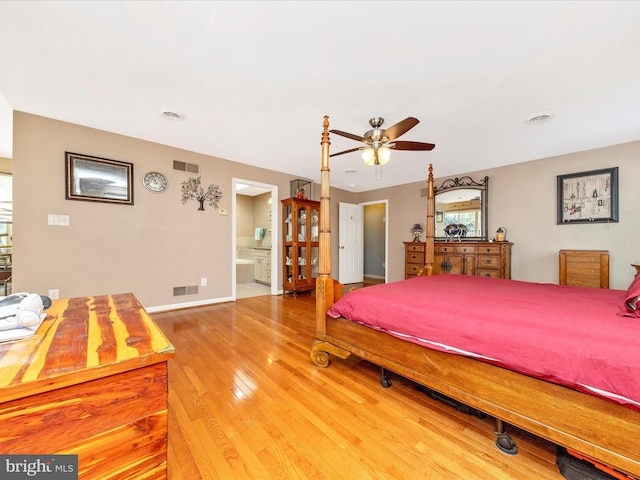 bedroom featuring ceiling fan, hardwood / wood-style floors, and ensuite bath