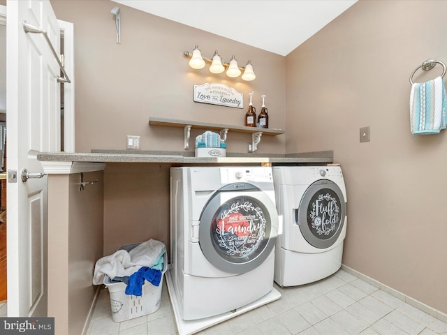 laundry room with light tile patterned flooring and washing machine and clothes dryer