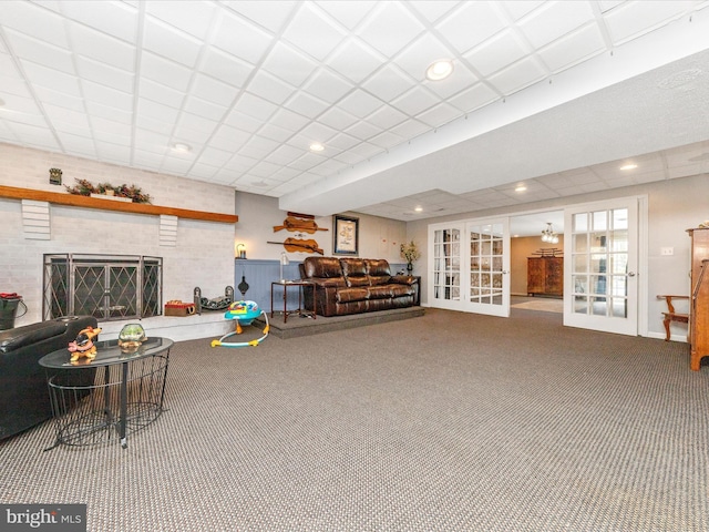 carpeted living room featuring a fireplace and french doors