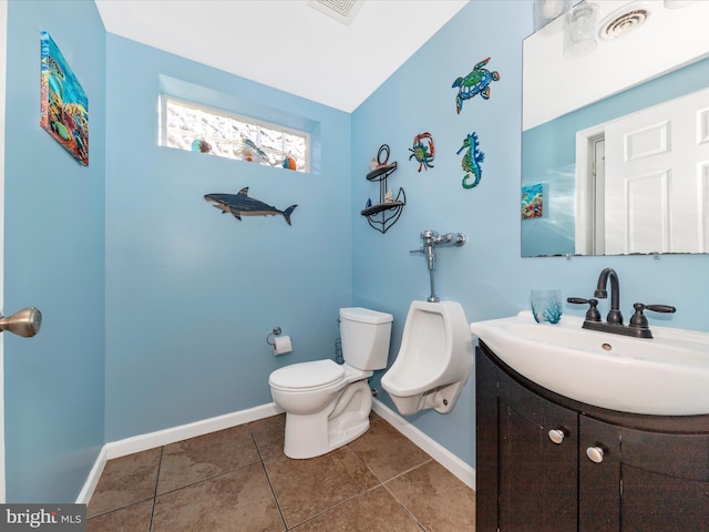 bathroom featuring tile patterned floors, toilet, vanity, and vaulted ceiling