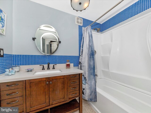 bathroom with decorative backsplash, tile patterned floors, vanity, and shower / bath combination with curtain