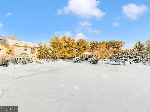 snowy yard featuring a gazebo