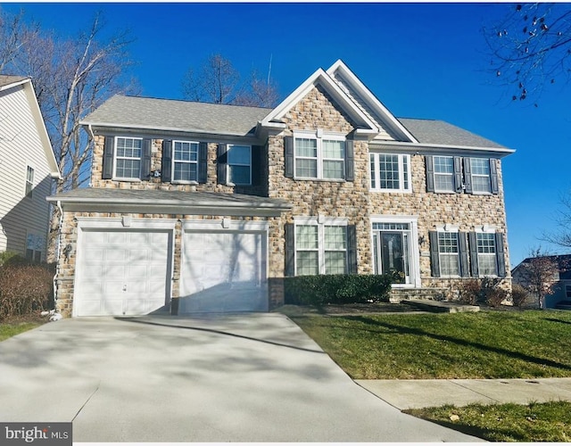 view of front of property with a garage and a front yard