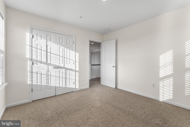 unfurnished bedroom with carpet floors and a closet