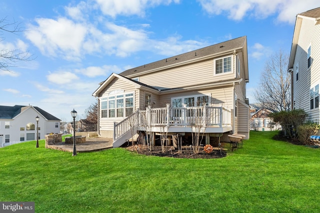 back of house featuring a wooden deck and a yard