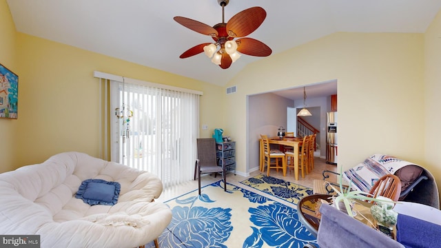 living room featuring vaulted ceiling and ceiling fan