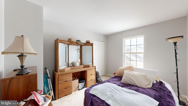 carpeted bedroom with a closet