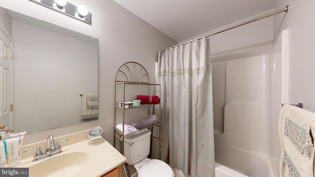 full bathroom featuring toilet, vanity, and shower / tub combo with curtain