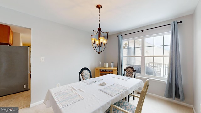 carpeted dining room featuring plenty of natural light and a chandelier