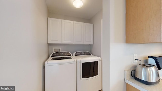 laundry room with cabinets and washer and dryer