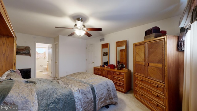 carpeted bedroom featuring ensuite bath and ceiling fan