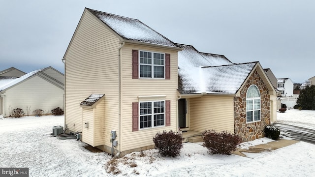 view of snow covered back of property