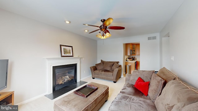 carpeted living room featuring ceiling fan