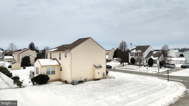 snow covered property featuring cooling unit