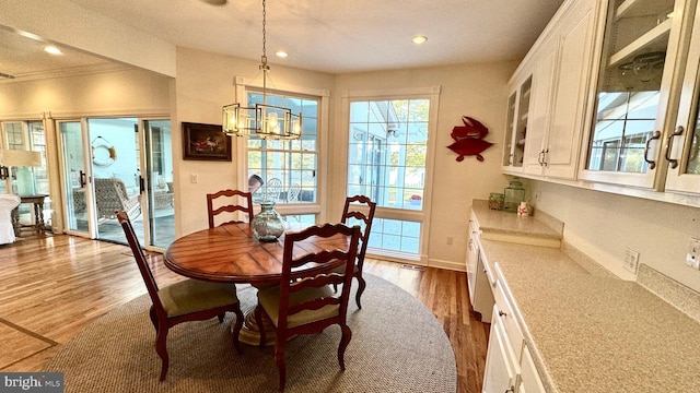 dining space featuring dark wood finished floors, a chandelier, recessed lighting, and baseboards