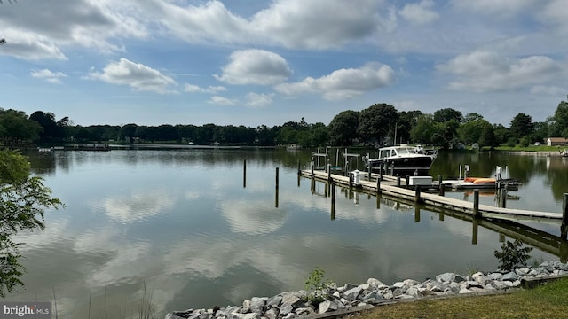 dock area with a water view and boat lift